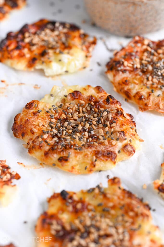 Crispy keto cottage cheese chips from side, topped with seeds as a high protein salty snack