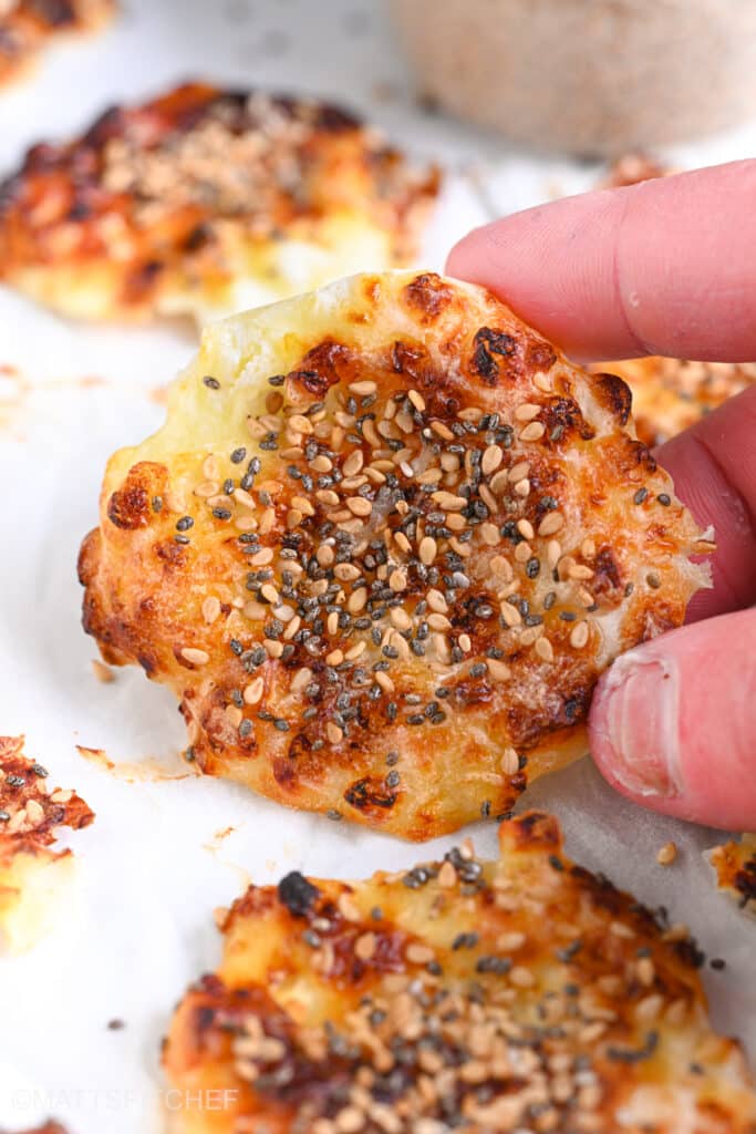 Cottage cheese chips from front, being lifted with the fingers