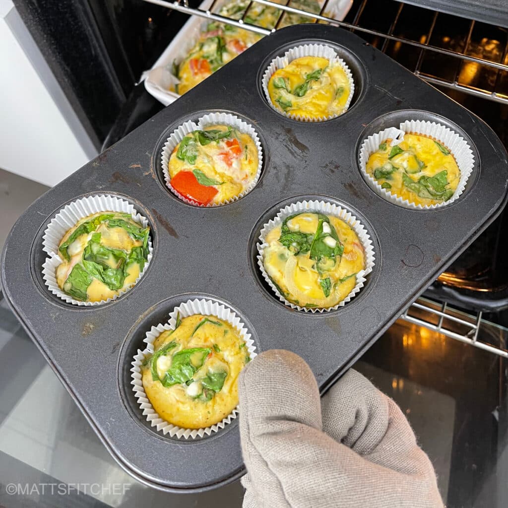 Baked cottage cheese egg bites being removed from oven