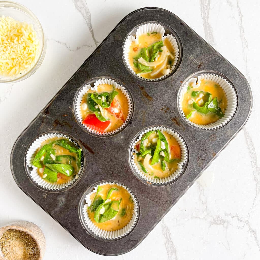 Cottage cheese egg bites in a muffin pan, ready to bake
