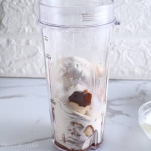 Adding protein powder to Greek yogurt and frozen bananas before blending into a creamy protein gelato