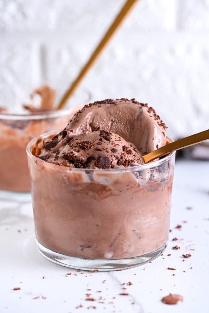 High Protein Ice Cream topped with a golden spoon, its rich and creamy soft-serve consistency is highlighted.