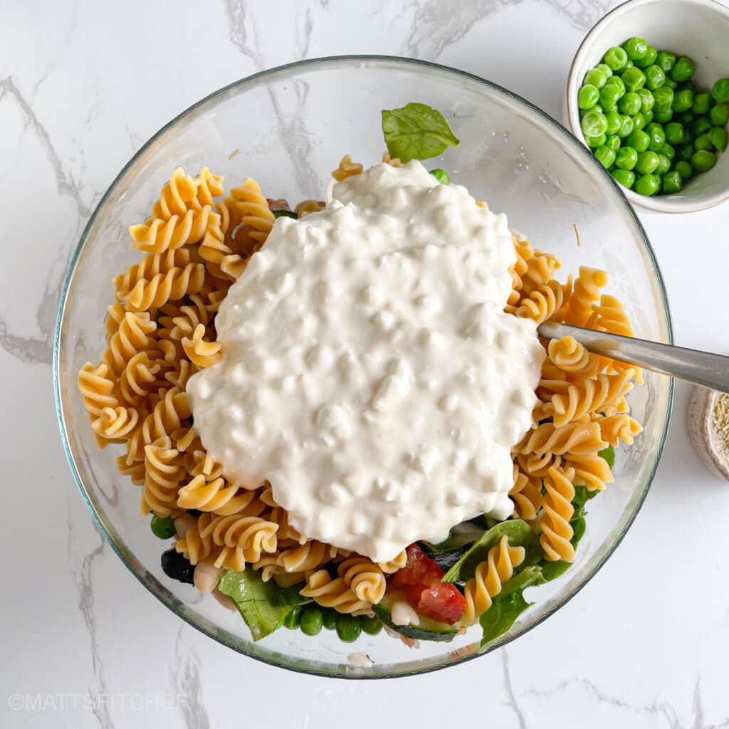 Cottage cheese added to cooked pasta and vegetables for more protein and a creamy texture