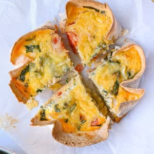 Cottage cheese Tortilla Quiche Bake sliced into quarters, ready to grab and eat as a high protein breakfast or lunch.