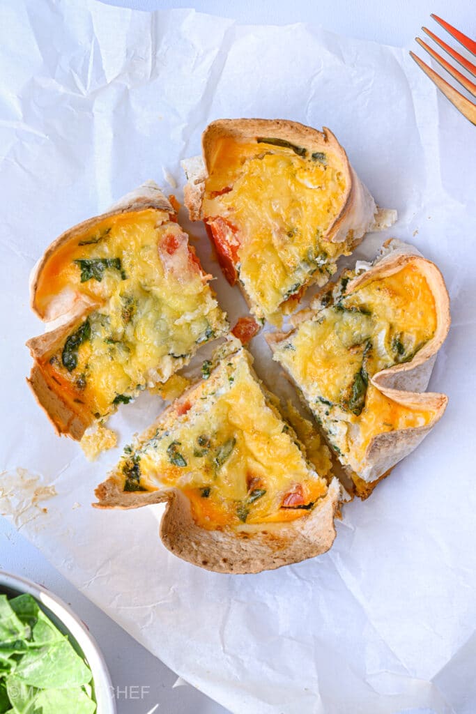 Cottage cheese Tortilla Quiche Bake sliced into quarters, ready to grab and eat as a high protein breakfast or lunch.