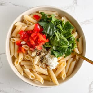 All components of the weight loss pasta salad in a bowl, ready to toss with a fork.