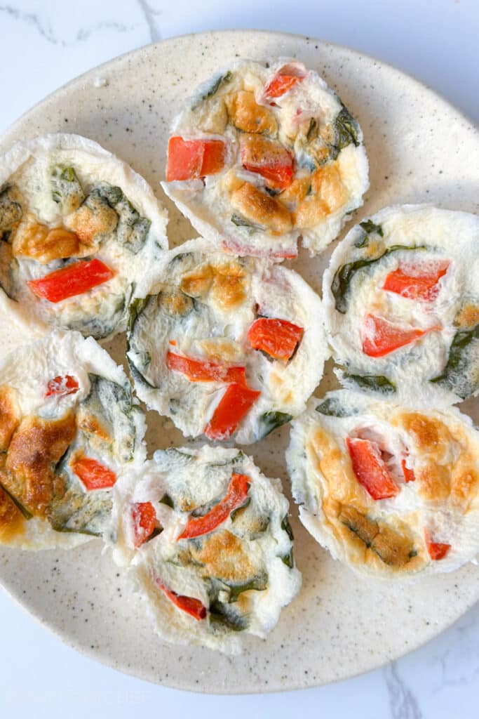 Top view of egg white bites in a plate, perfect as a low calorie and high protein snack or breakfast.