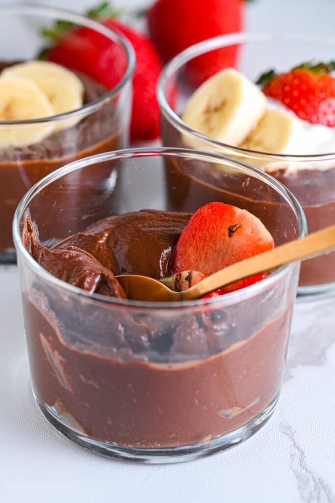 Creamy avocado chocolate mousse with sliced strawberries on top