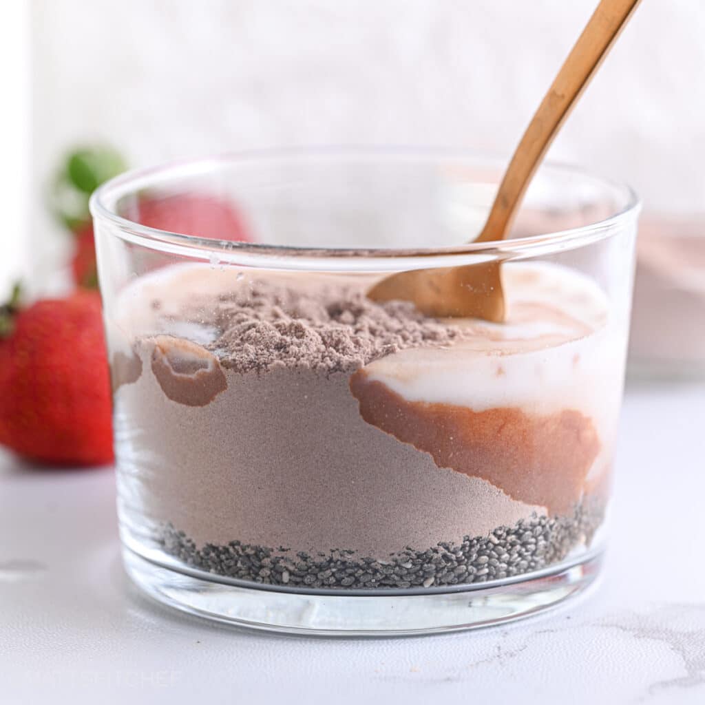 Mixing cocoa powder with chia seeds, milk and maple syrup