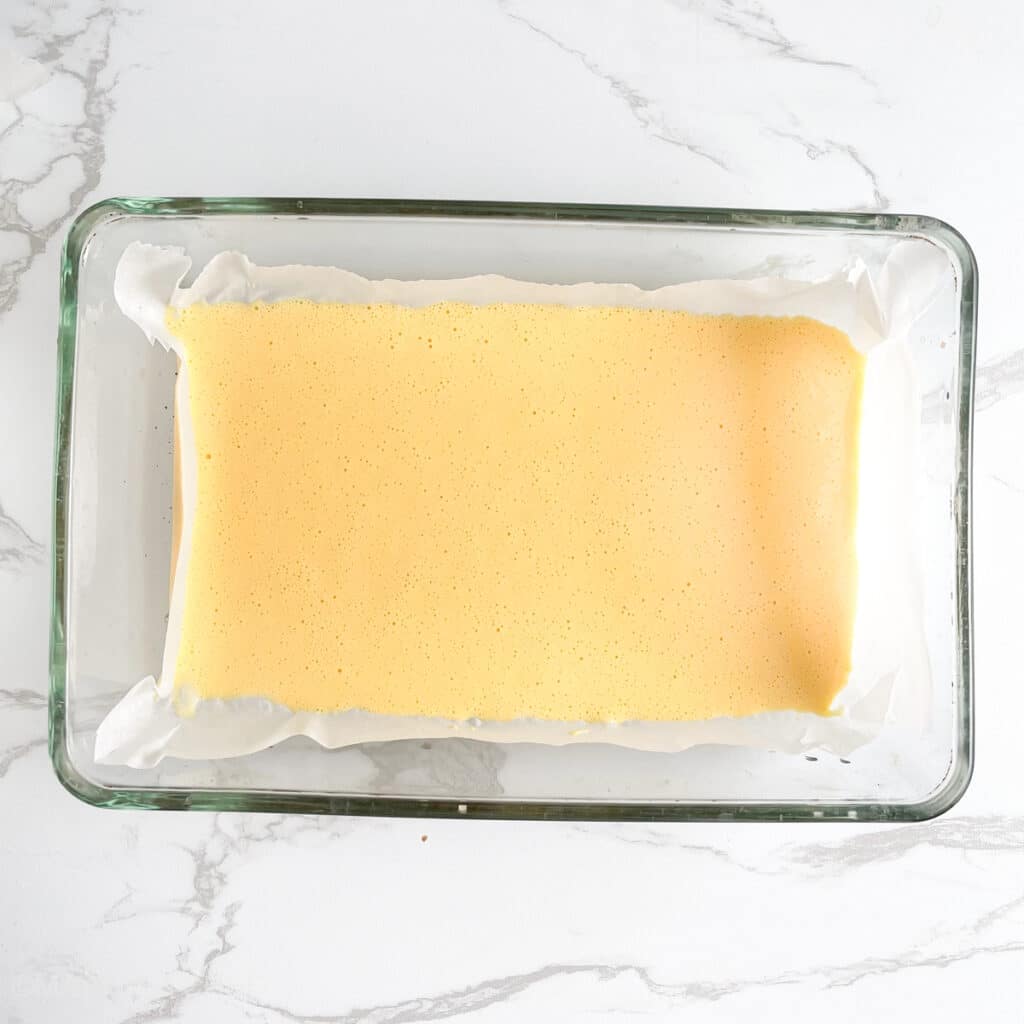 Blended cottage cheese and eggs in parchment paper lined pan