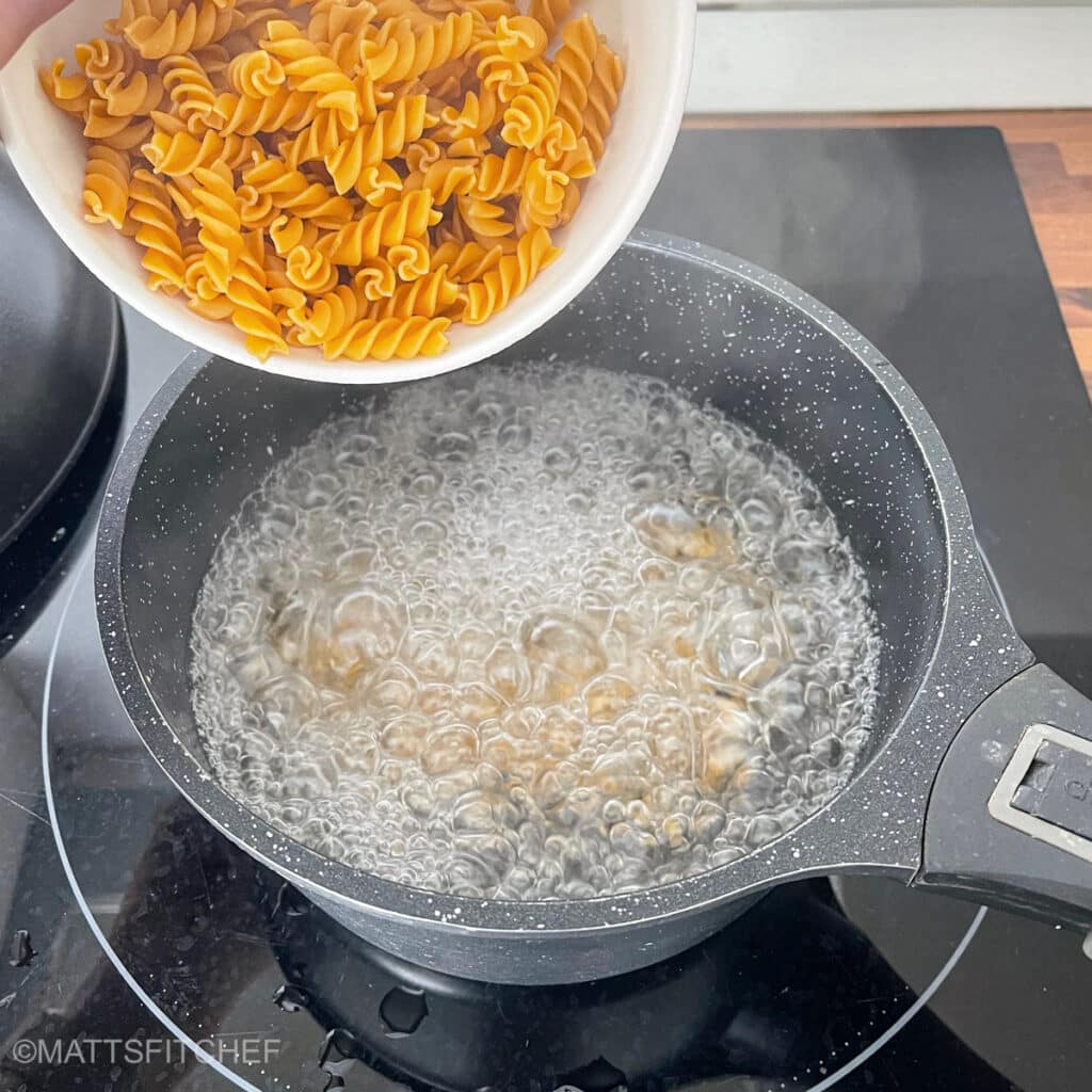 Adding chickpea pasta to boiling pasta water