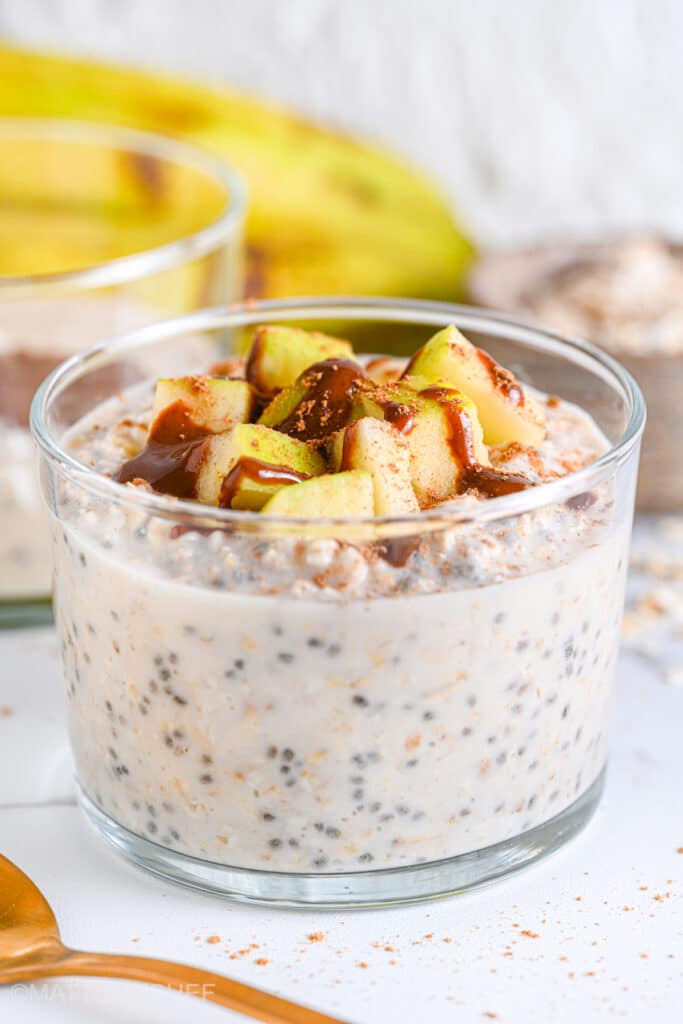 Close up of cottage cheese overnight oats with diced apple, almond butter and sprinkle of cinnamon