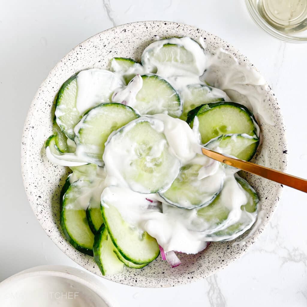Mixing creamy cucumber yogurt salad