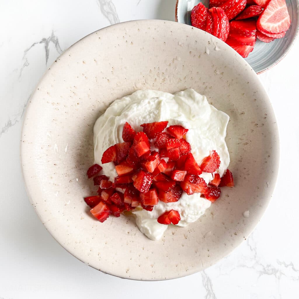 Diced strawberries added to honey Greek yogurt