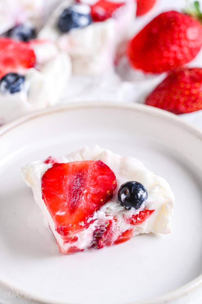 Frozen yogurt bar with strawberries and blueberries as healthy topping