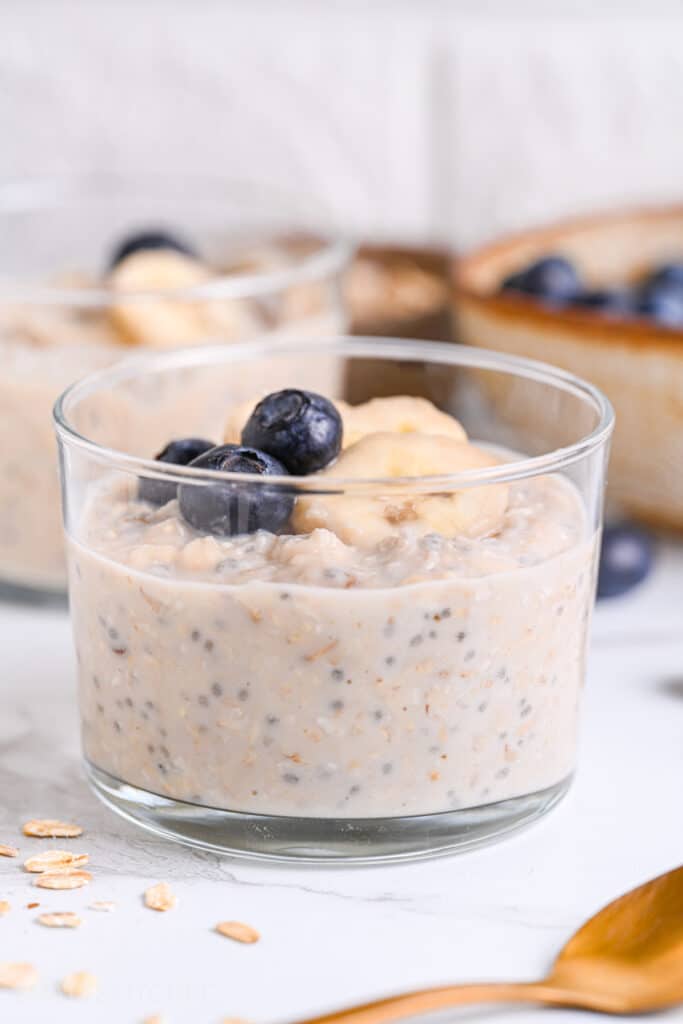 Meal prep overnight oats with protein powder, served with juicy blueberries and sliced banana