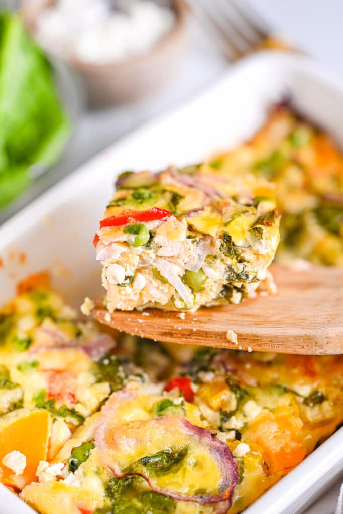 Wooden spatula serving a slice of high protein egg casserole with cottage cheese
