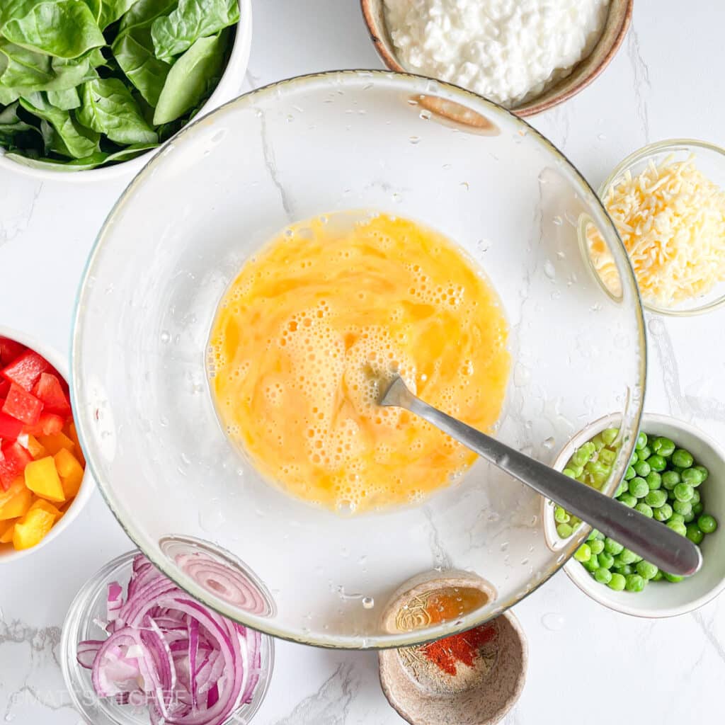 Beaten eggs in a large bowl