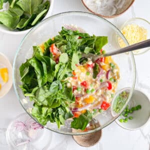 Mixing in cottage cheese and eggs spinach