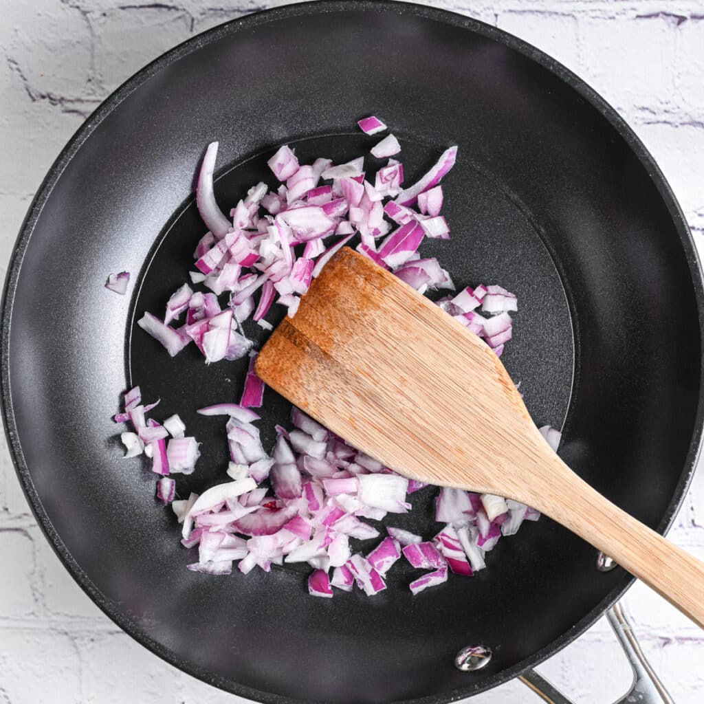 diced onion in a skillet, ready to saut&eacute; with garlic as pasta sauce aromatics