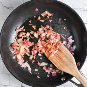 Sautéing onion and garlic in a skillet before blending with cottage cheese