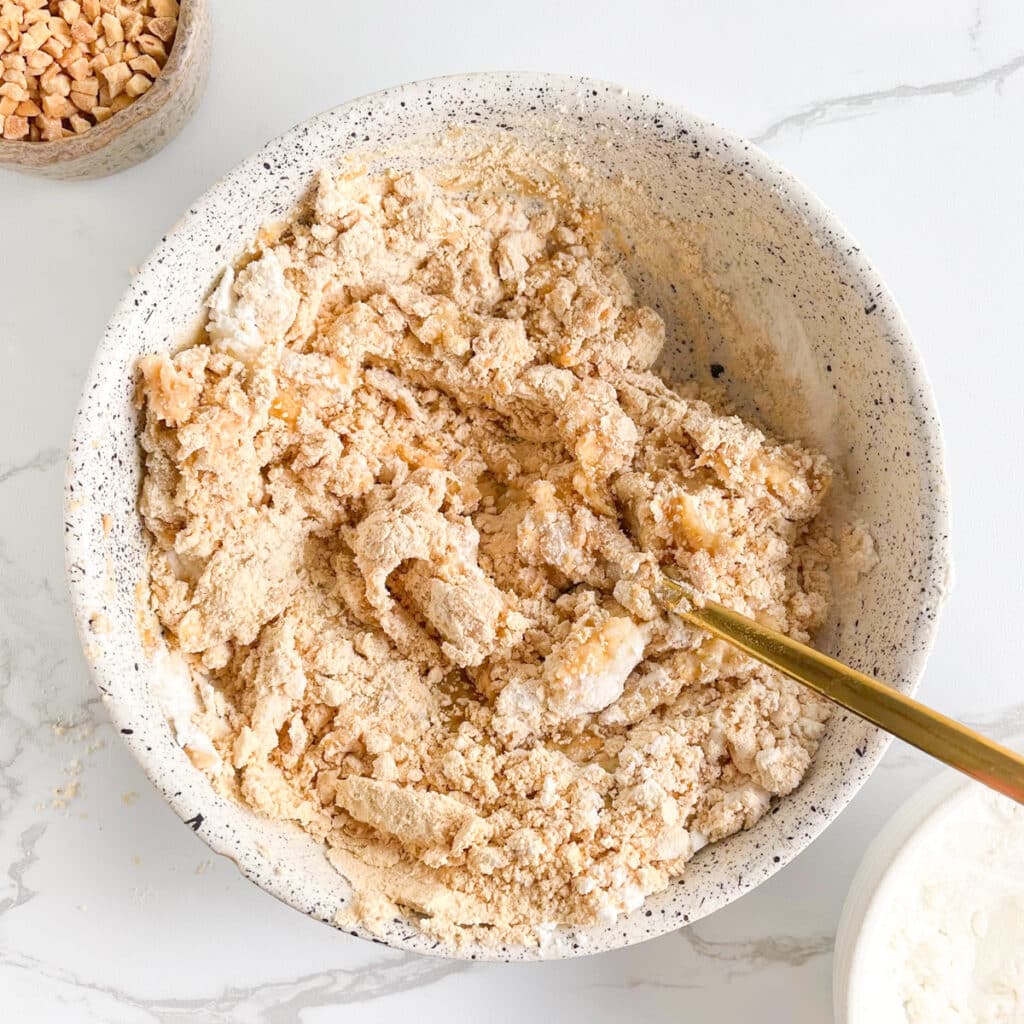 Mixing powdered peanut butter with protein powder and mashed banana