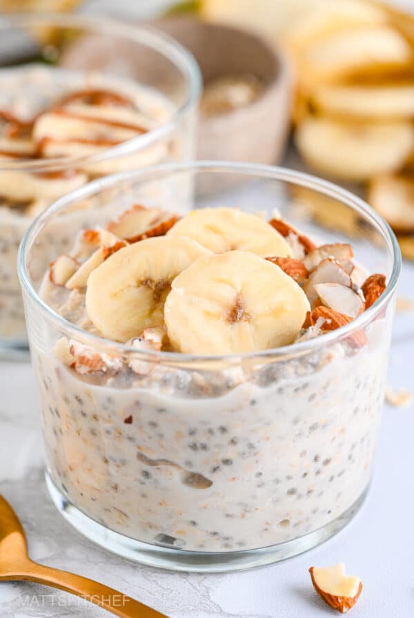 Healthy overnight oats with yogurt, topped with sliced banana and chopped almonds