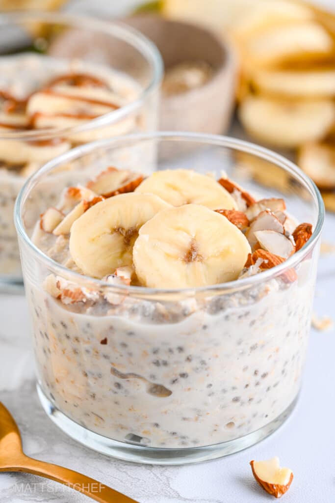 Healthy overnight oats with yogurt, topped with sliced banana and chopped almonds