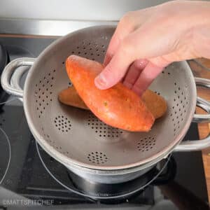 Adding sweet potatoes to strainer to steam for 30 minutes until tender