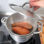 Covering the pot with steamer with a lid, for steaming