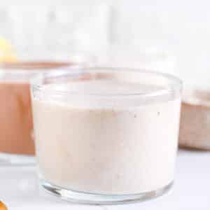 Front view of vanilla protein shake in transparent glasses