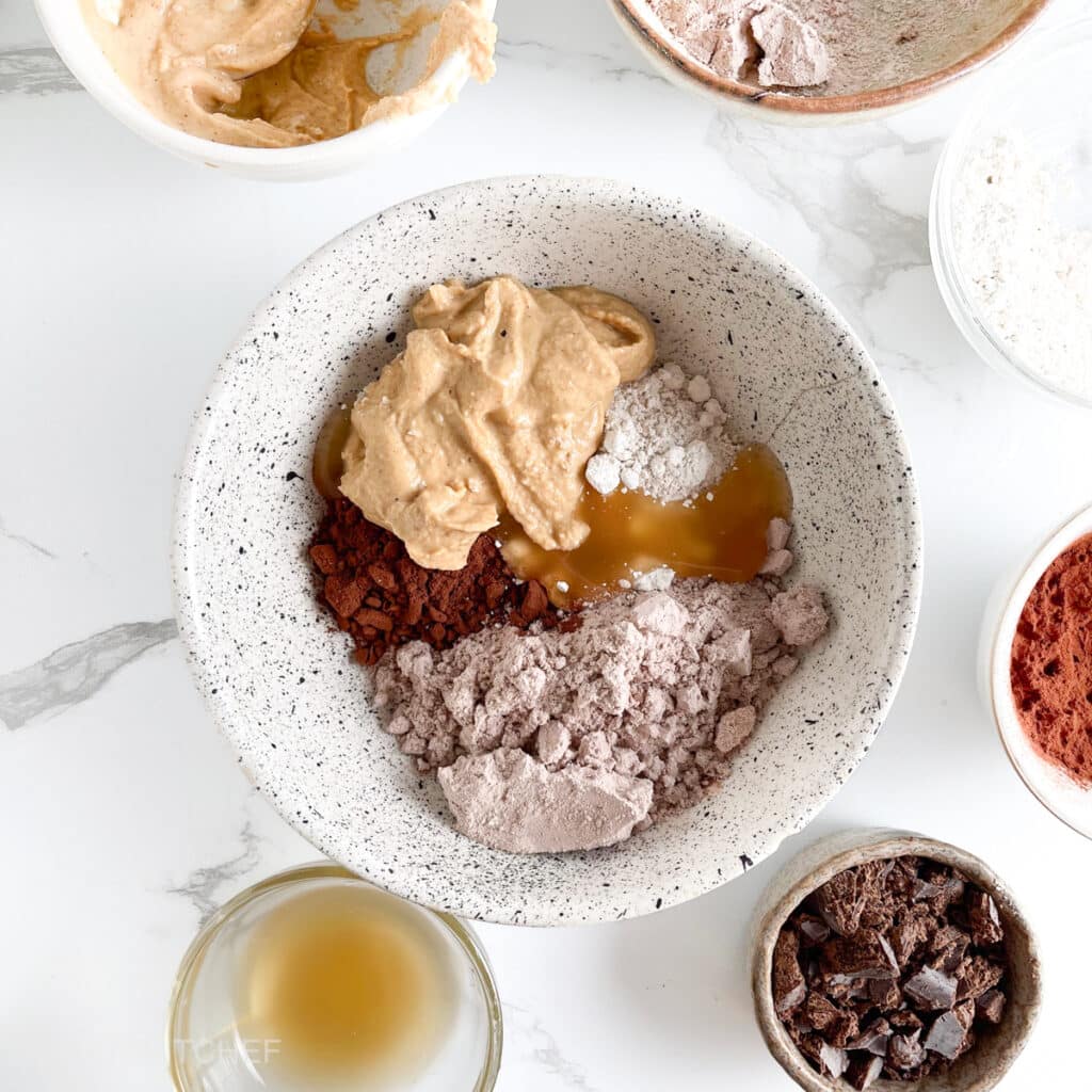 All ingredients for high protein brownie balls in a bowl, before mixing in a smooth batter