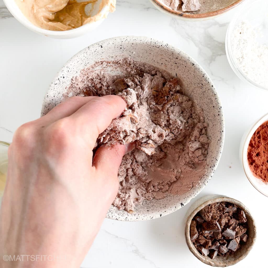 Kneading ingredients with the help of left hand, adjusting texture as needed