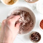 Kneading ingredients with the help of left hand, adjusting texture as needed