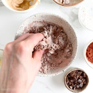 Kneading ingredients with the help of left hand, adjusting texture as needed