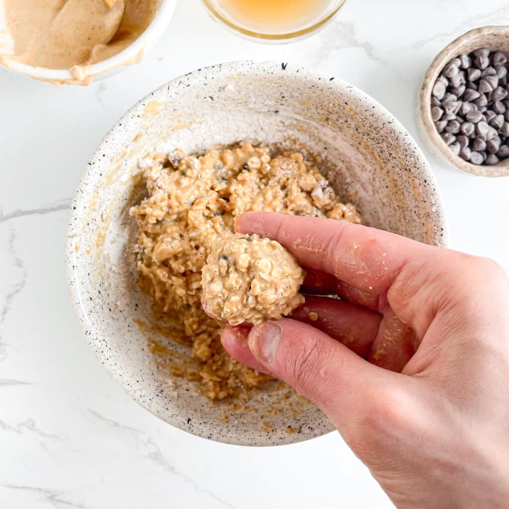 Shaping protein oat energy bites with hands