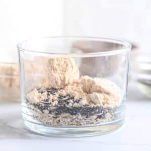 Powdered peanut butter with rolled oats and chia seeds in a glass
