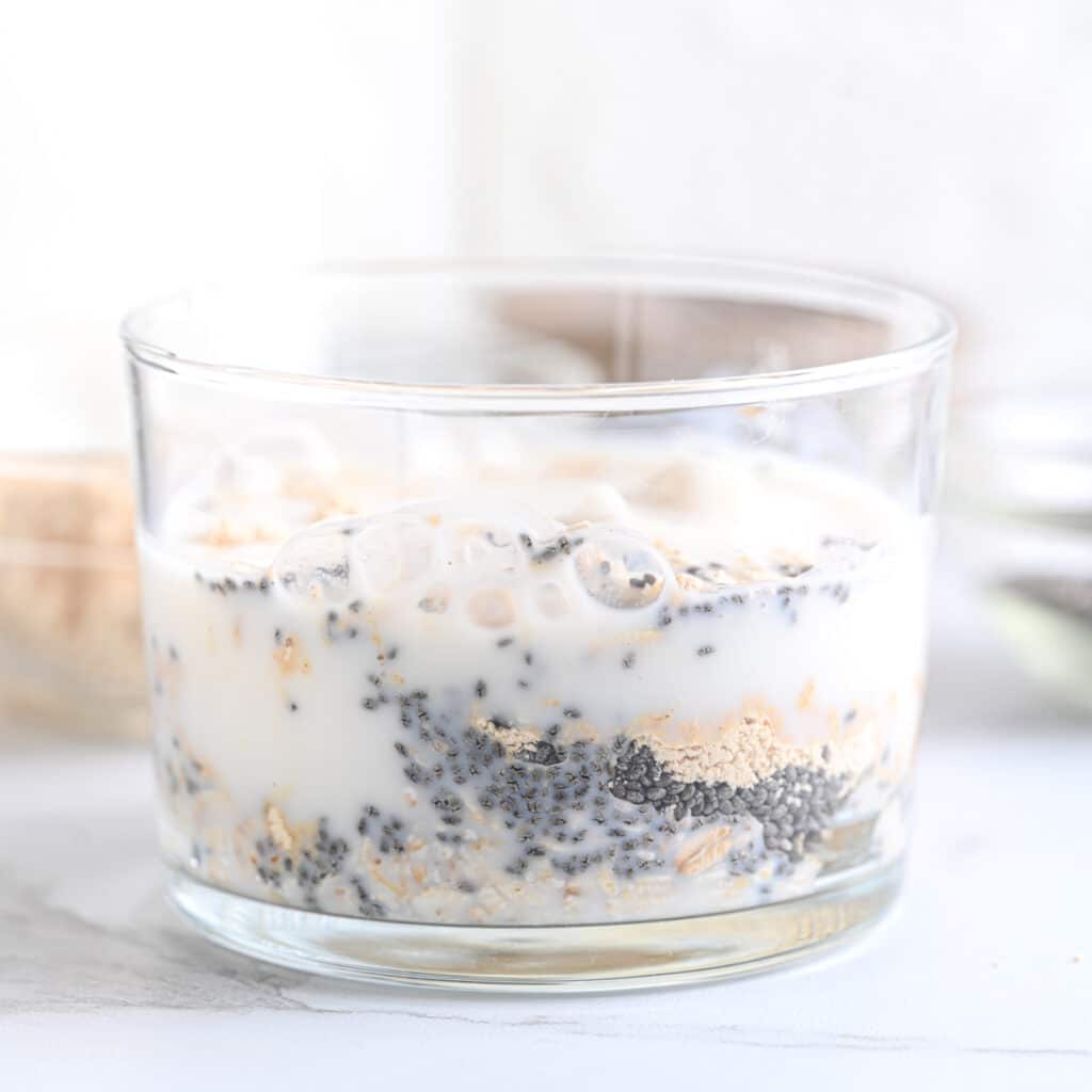 Adding milk to pb2 and oats in a glass
