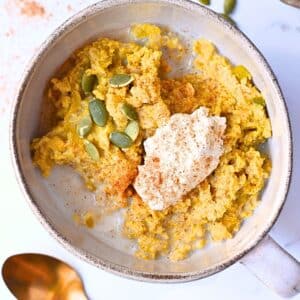 High protein pumpkin oatmeal with pumpkin seeds and cottage cheese as toppings