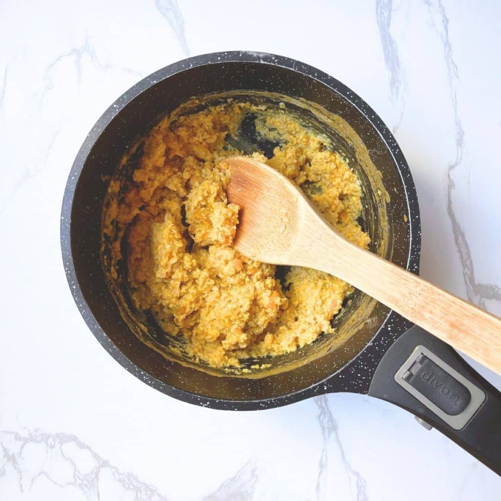 Creamy cooked pumpkin oatmeal in saucepan